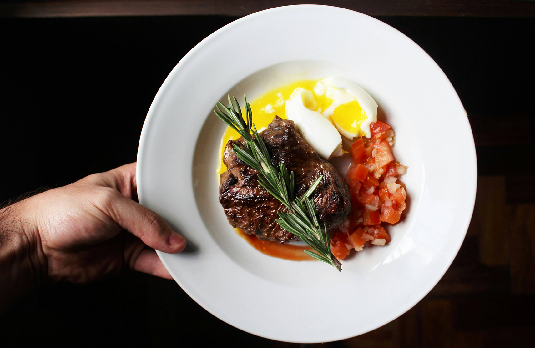 plate of steak, eggs, and tomato